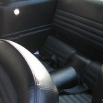 The interior of a classic car with leather seats.