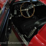 The interior of a red mustang.