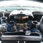 The engine compartment of a classic car.