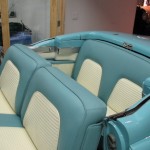 The interior of a blue and white classic car.