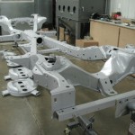 A car frame is being made in a workshop.