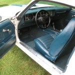 The interior of a white and blue muscle car.