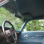 The interior of a blue car with a steering wheel and steering wheel.