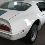 A white sports car parked in a garage.