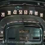 The dashboard of a classic car with a clock.