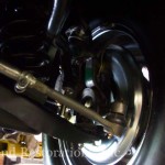 A close up of a vehicle's wheel and suspension.