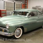 Side view of green color car for repair on the display