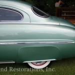 Back view of green color car for repair on the display