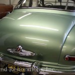 Close view of green color car for repair on the display