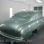 Close view of green color car for repair on the display